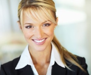 Closeup portrait of a cute young business woman smiling - Copyspace